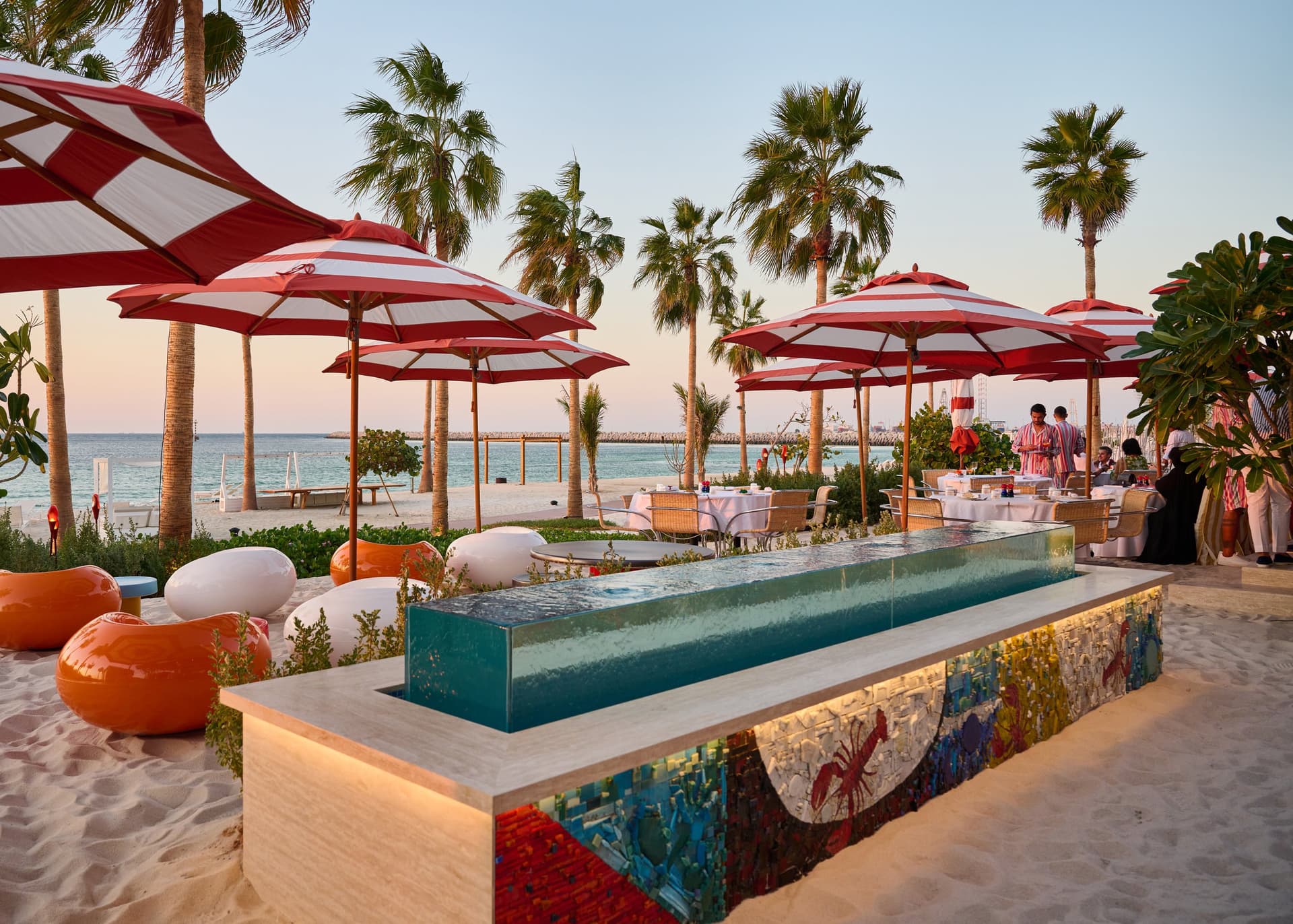 Striped parasols and teal banquettes at Bungalo34