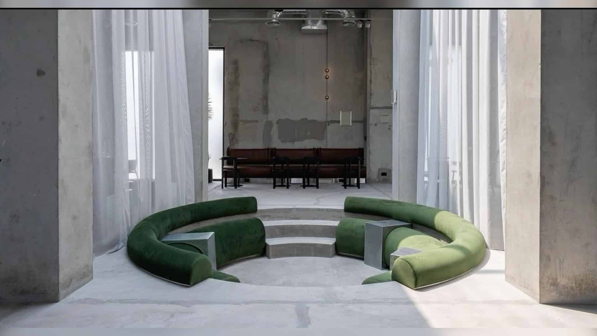 Concrete columns and green sofas at KONCRETE