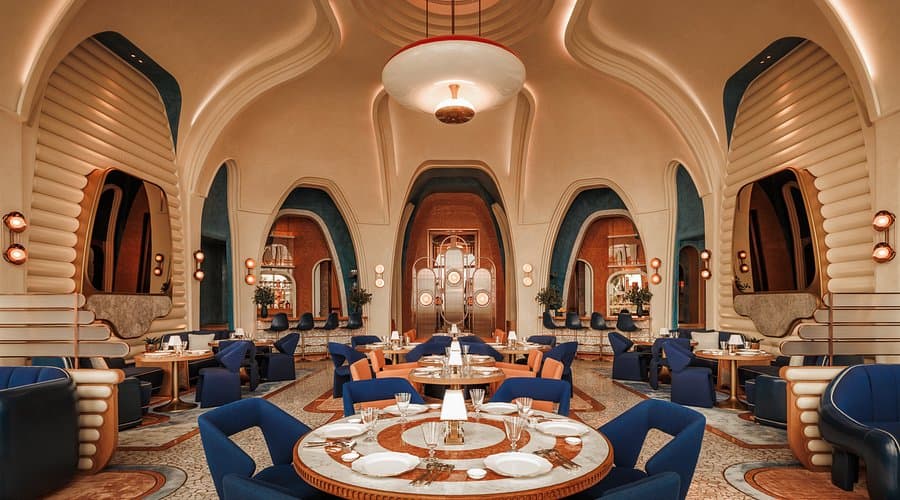 Rialto’s arched dining room with blue velvet chairs