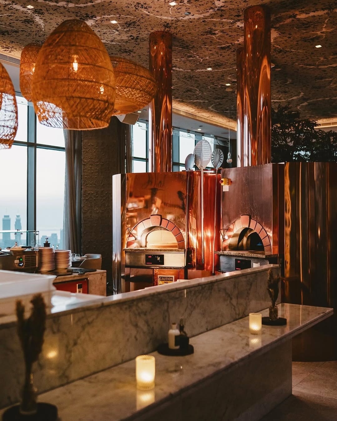 Copper pizza ovens behind Fi’lia’s marble bar
