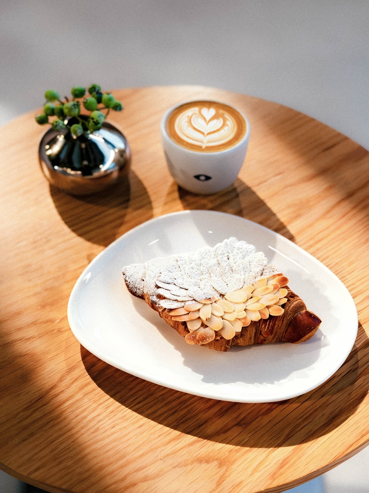 An almond croissant and latte at Julith