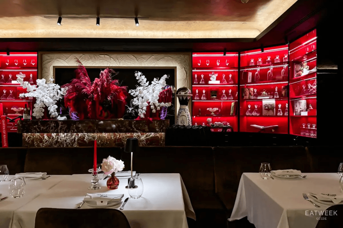 White blooms against NAHATÉ's red display wall