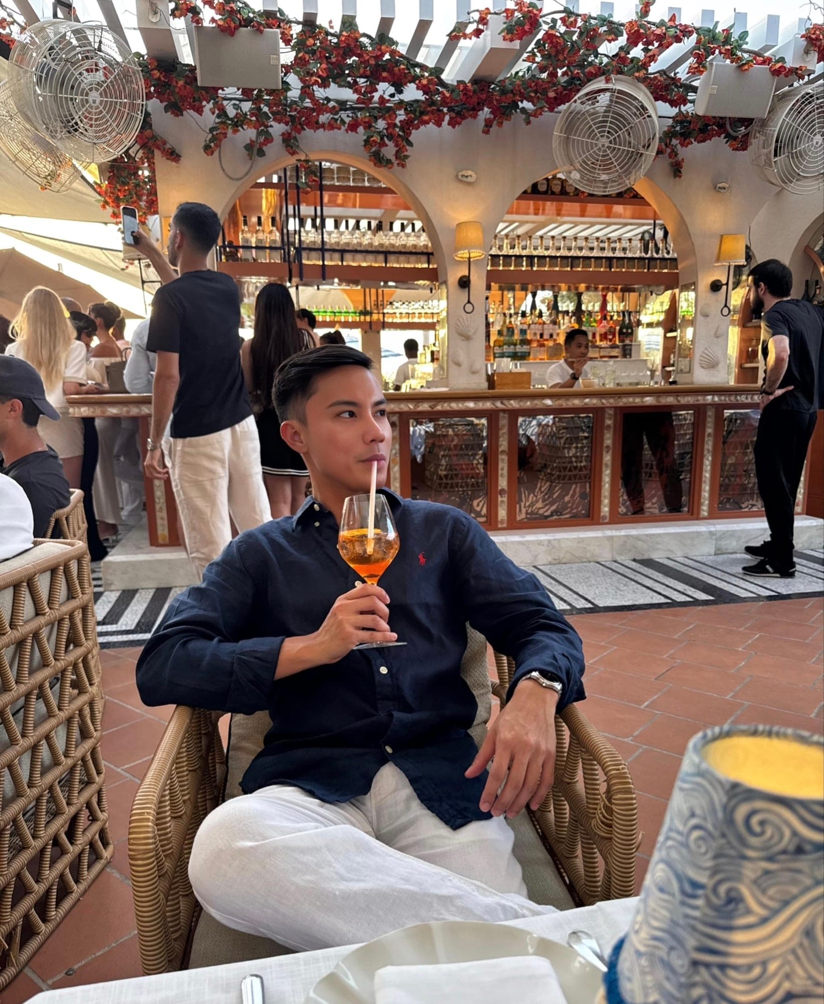 Aaron with an Aperol spritz on the terrace at Sirene by GAIA