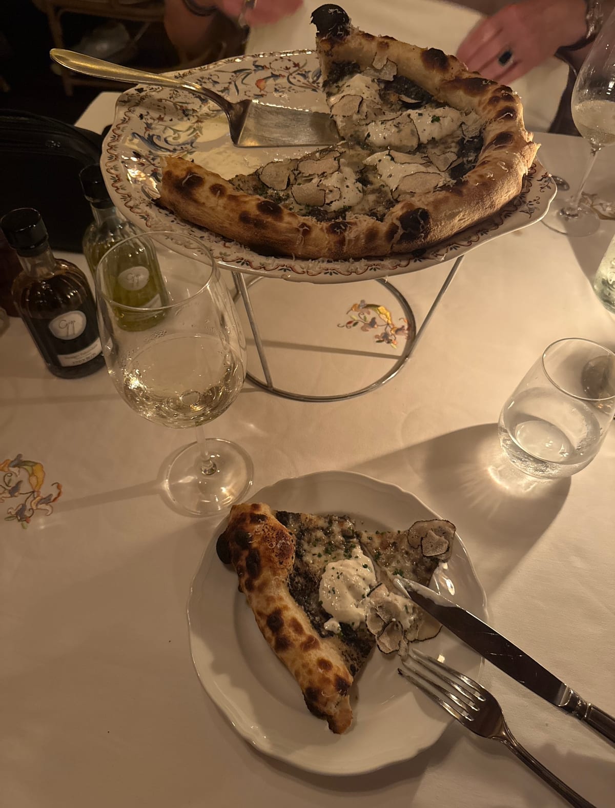 Truffle pizza served at the table at Gigi Rigolatto
