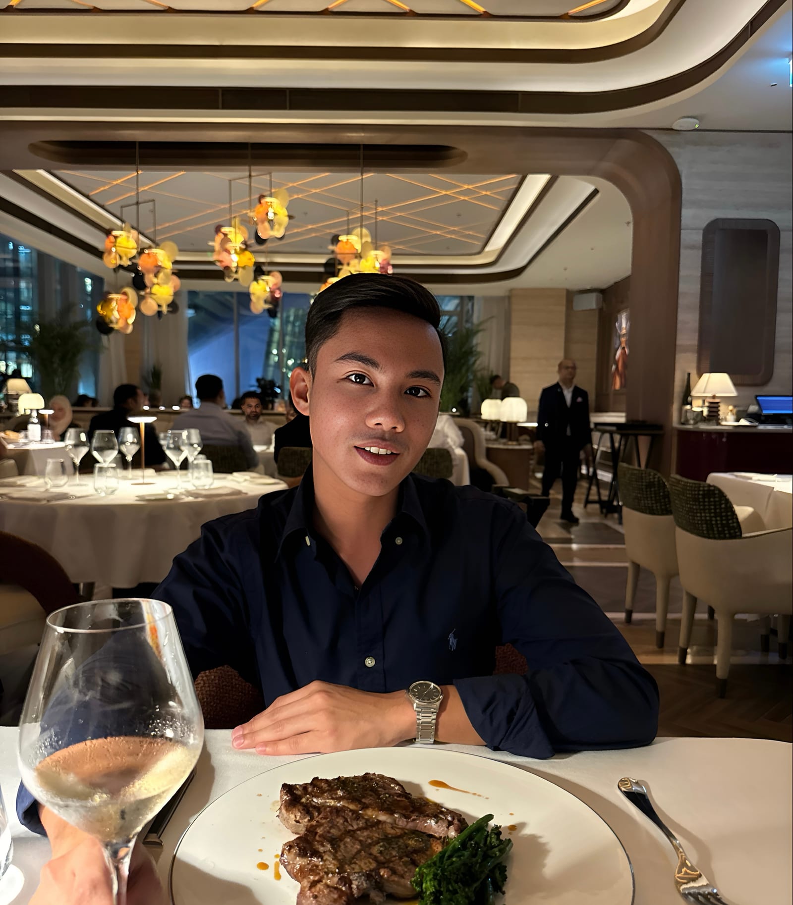 Aaron at dinner at Roberto’s, a steak on the table