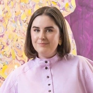 Emilie Hill in front of a colourful painting