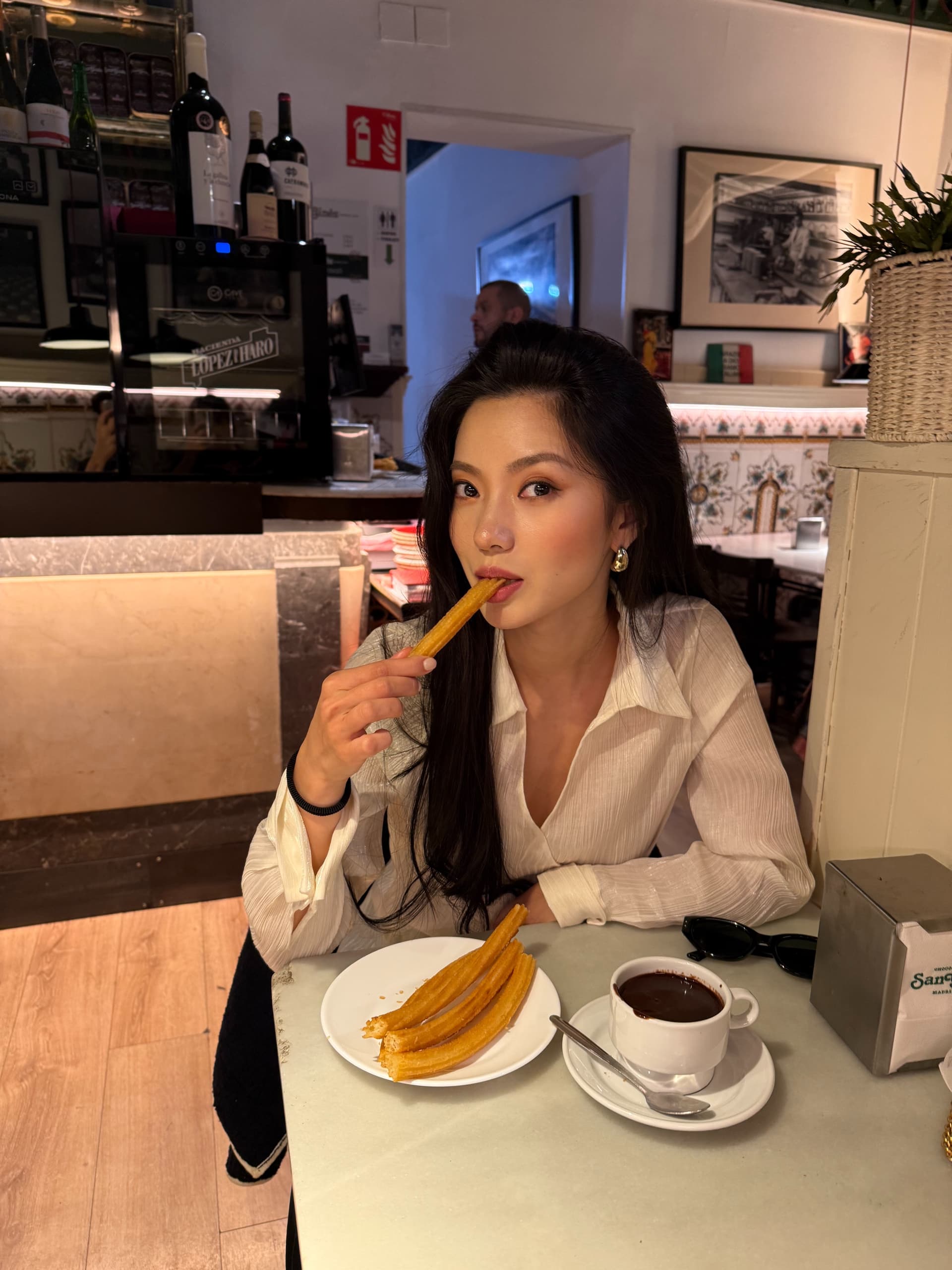 Vailey dunking a churro at the chocolatería