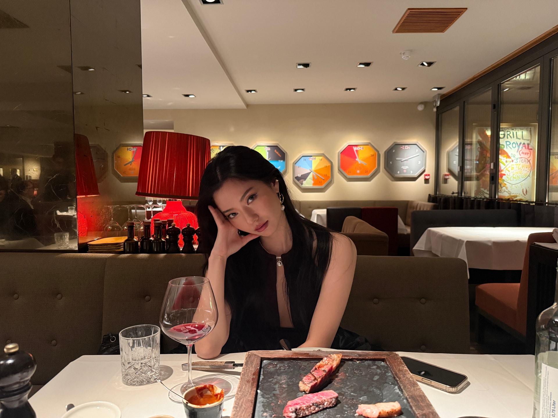 Vailey at the steakhouse while her steak sears on the stone