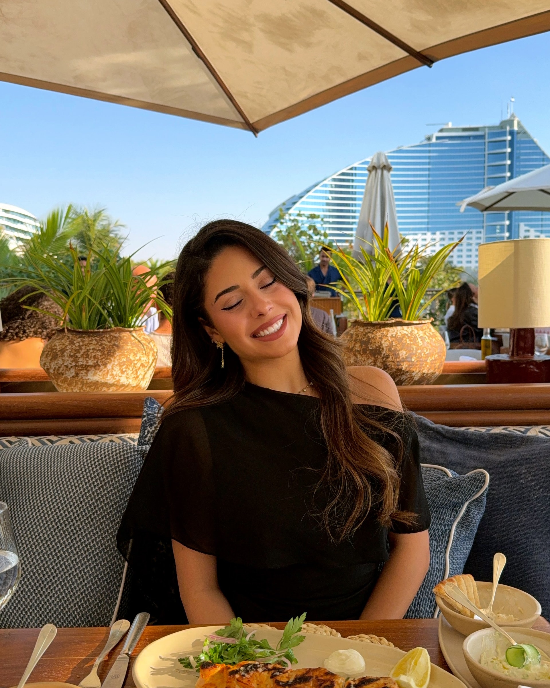 Letty at a terrace table with the Burj Al Arab behind