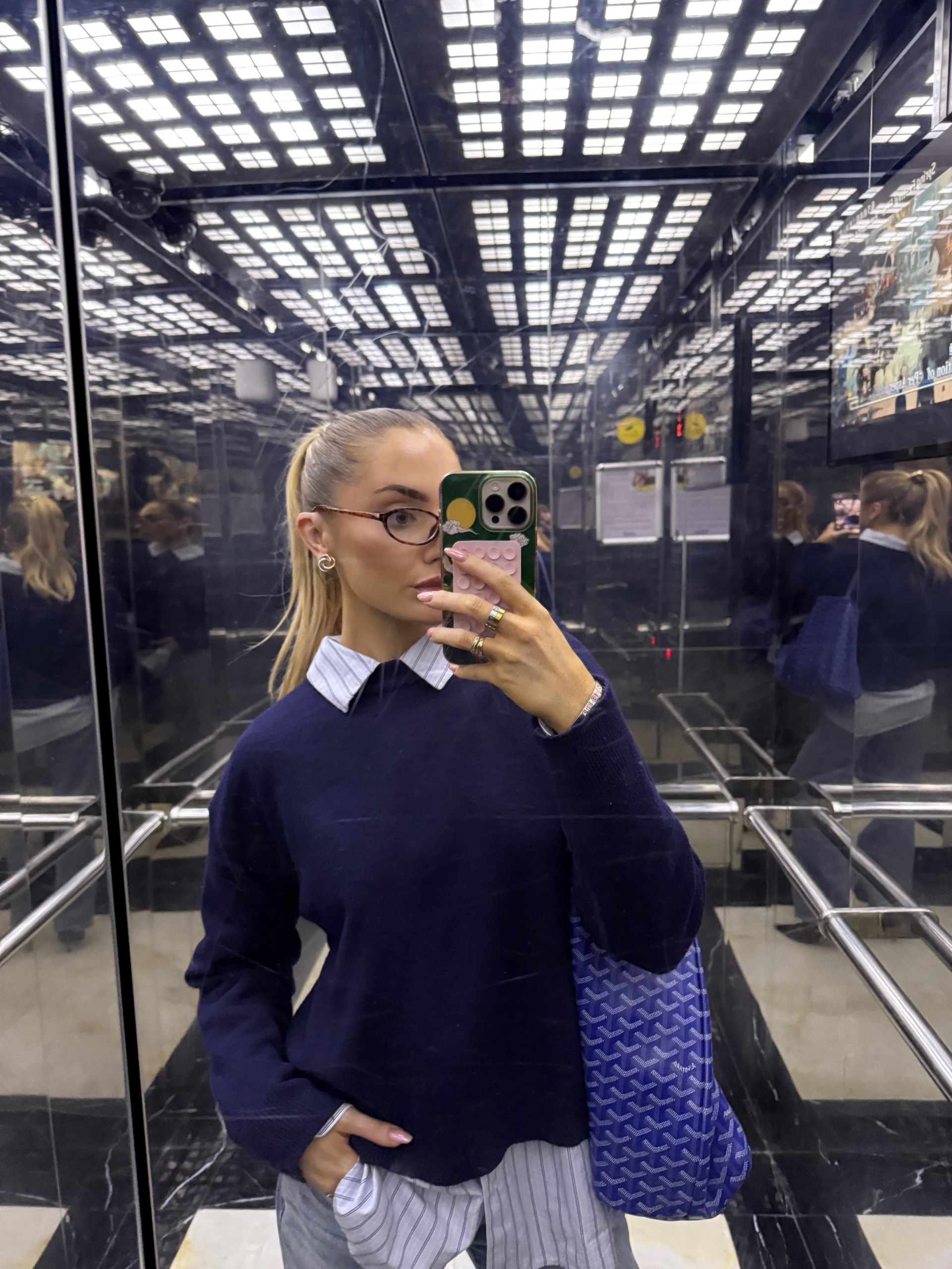 Orla in office knitwear, elevator mirror selfie