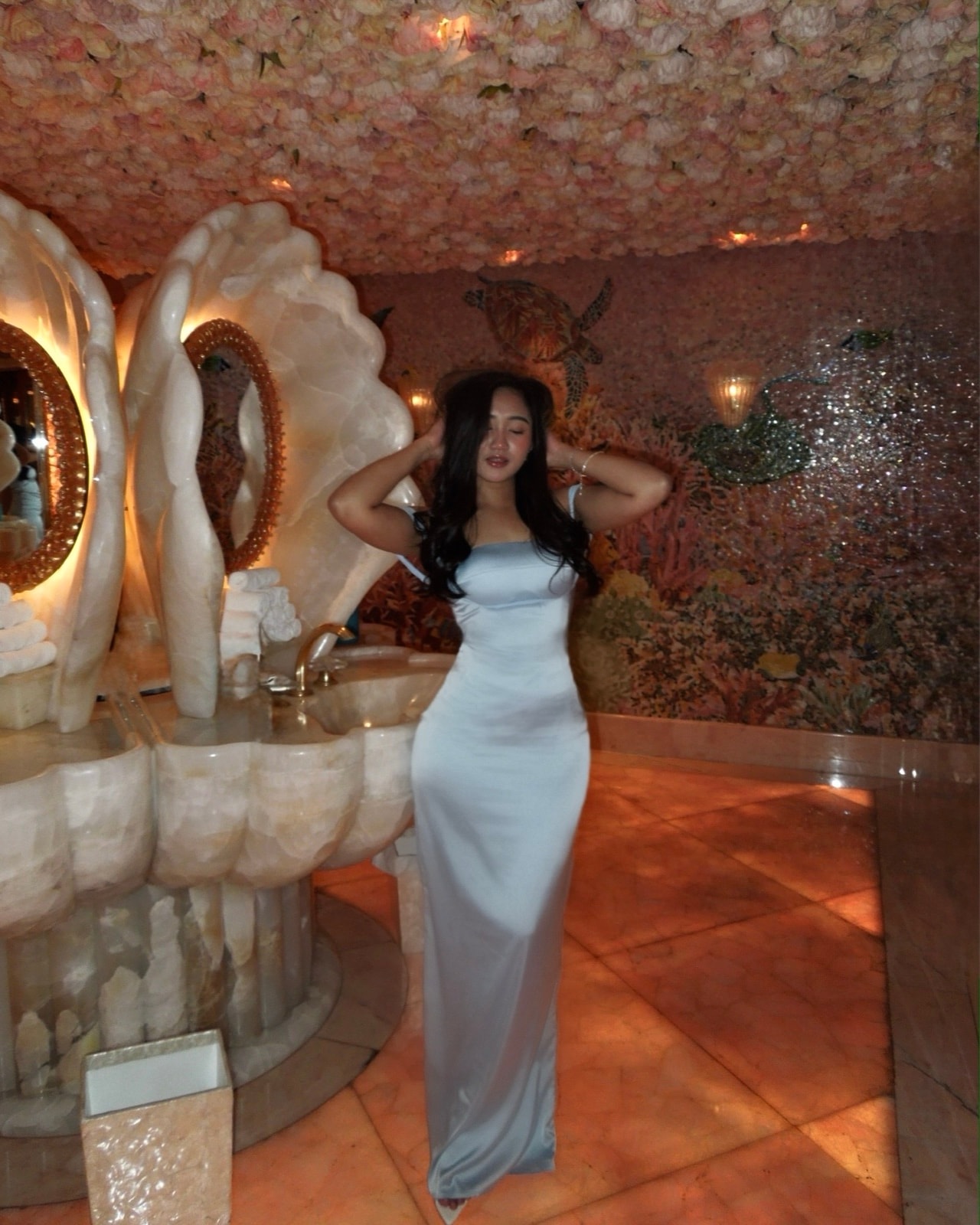 Rhoda in silver under a gilded mirror
