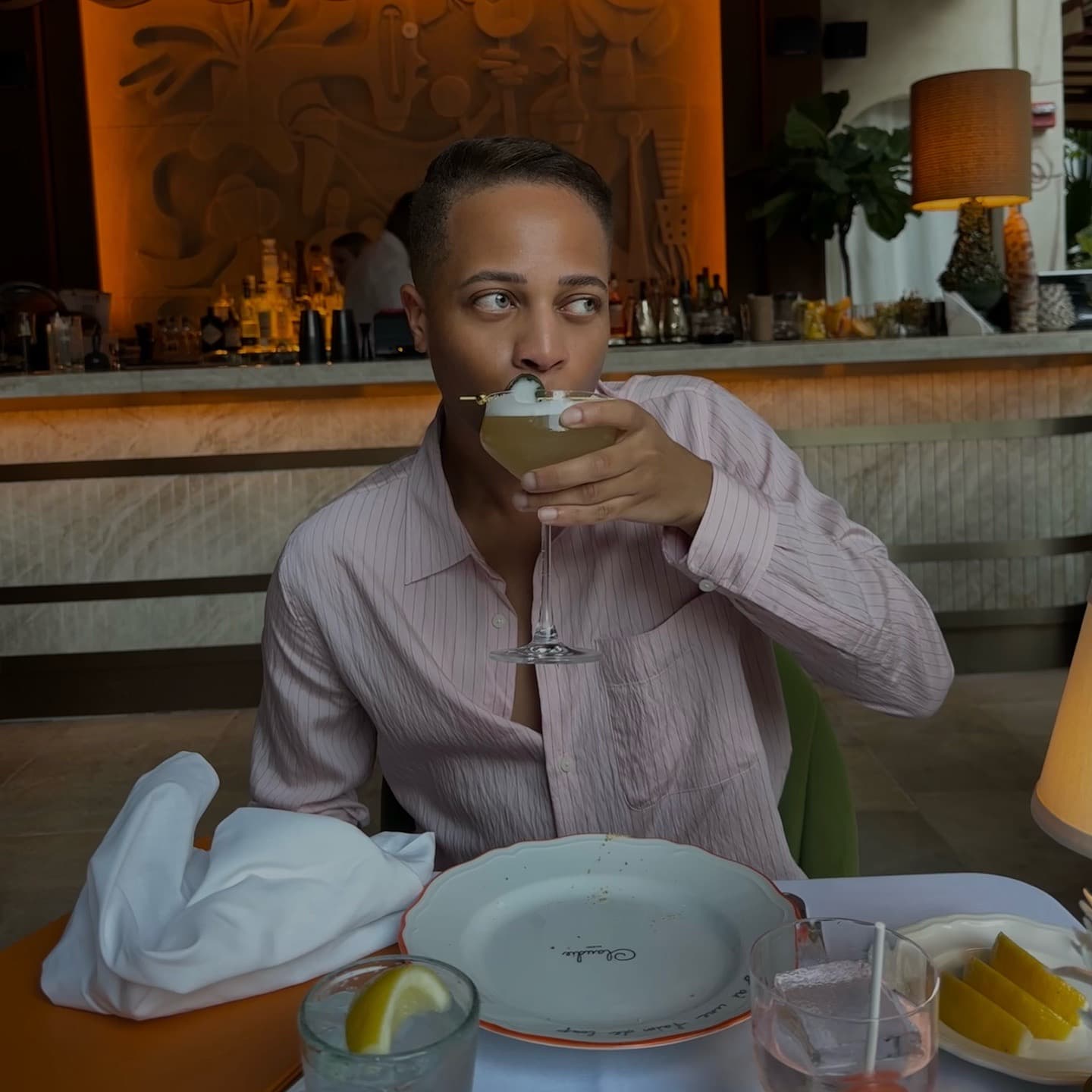 Ty sipping a cocktail at Claudine