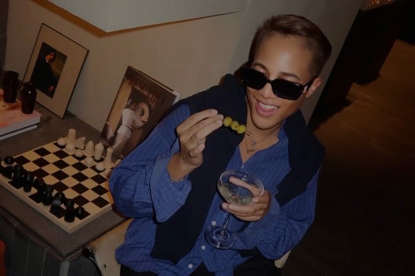 Ty with a martini and a skewer of olives