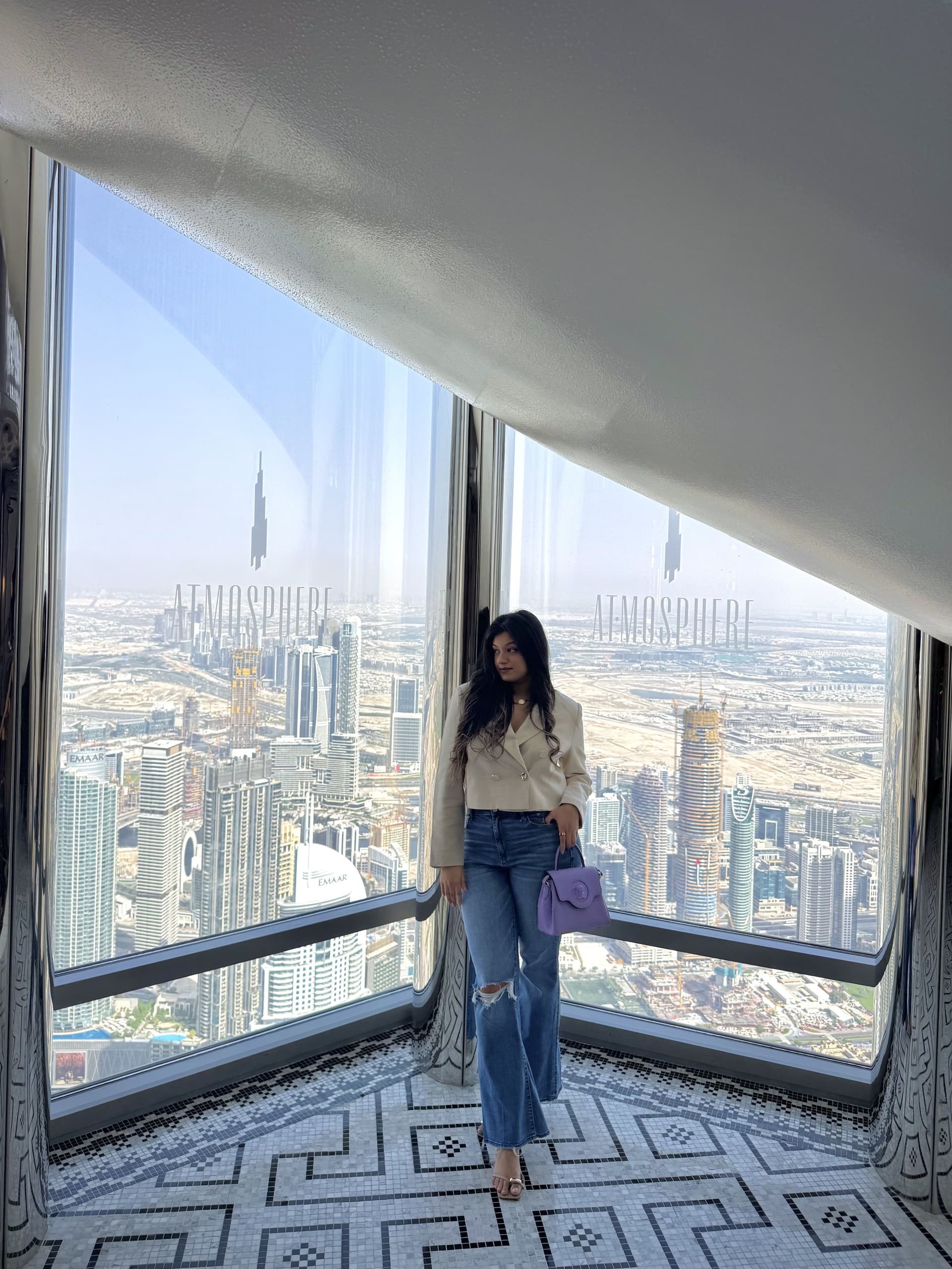Vama at a high window over the Downtown skyline