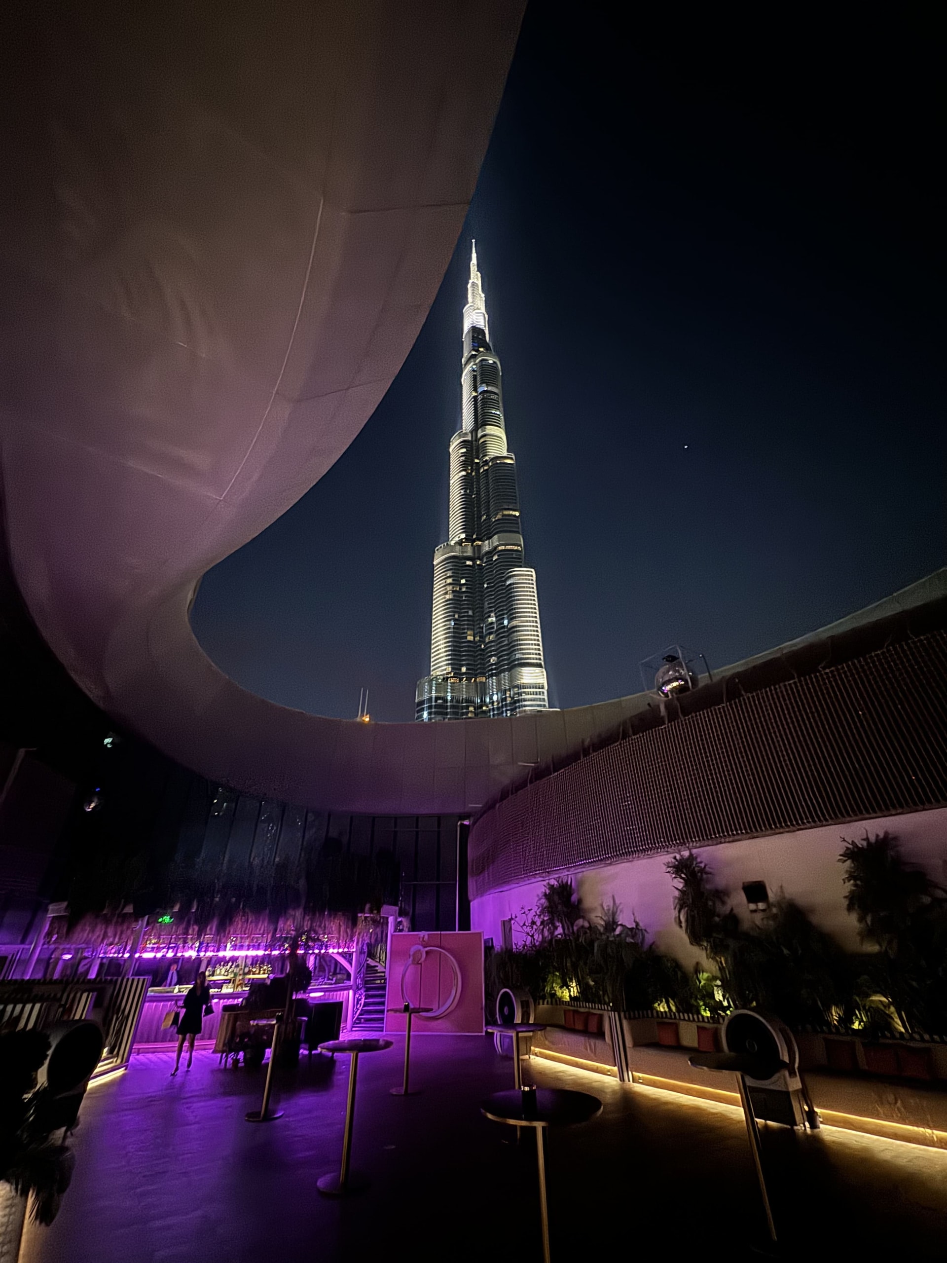 Eden Bar’s garden terrace glowing under the Burj Khalifa