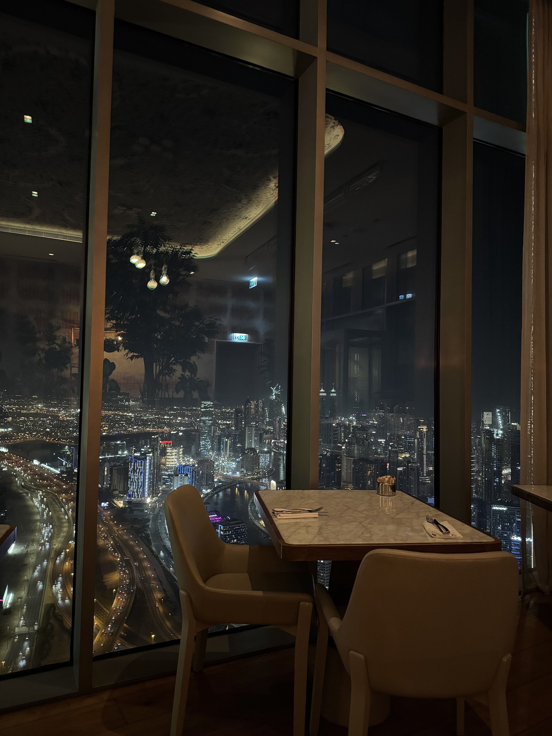 Vama’s window table over the skyline, after dark