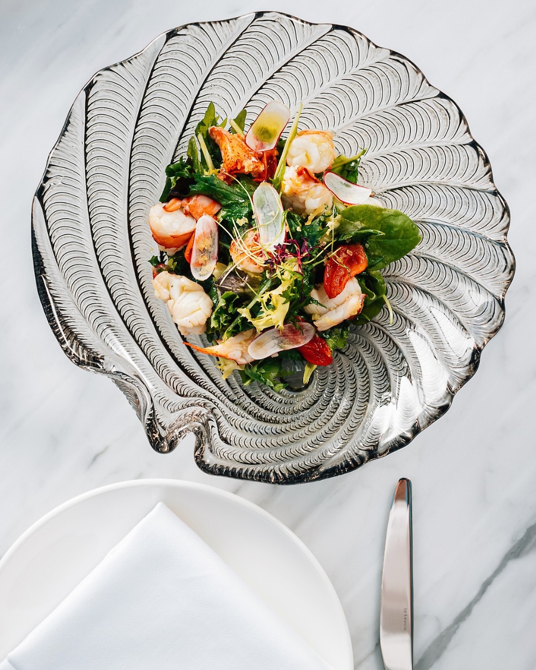 A seafood starter served on the shell at DUOMO