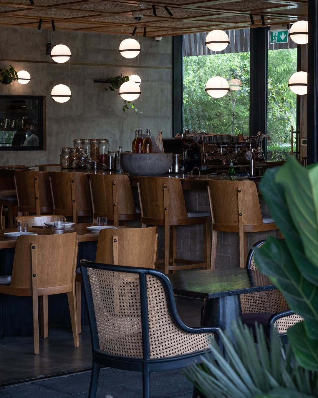 Wood and woven chairs along LOWE’s bar