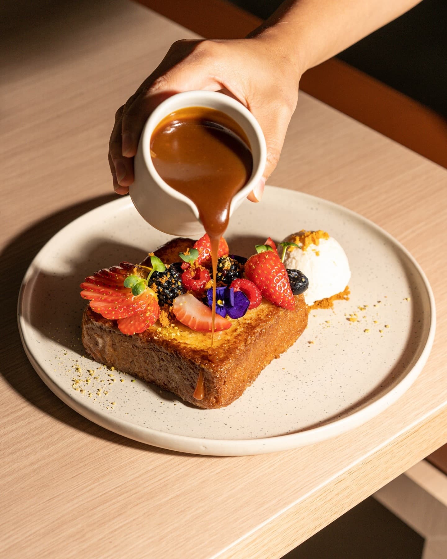 Sauce poured over Milk Bakery's french toast